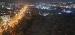 a city lit up at night with street lights at Квартира со всеми удобствами in Osh