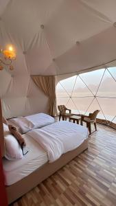 a bedroom with a large bed in a tent at wadi novas camp in Wadi Rum