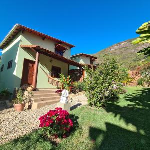 a small house with flowers in front of it at Green Chales - Vale do Capão in Vale do Capao