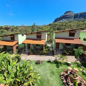 a house with a garden and mountains in the background at Green Chales - Vale do Capão in Vale do Capao +61 photos