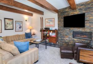 a living room with a couch and a fireplace at Vantage Point 112 Condo in Vail