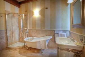 a bathroom with a tub and a sink and a shower at Relais La Colombara Spa & Wellness in Travo