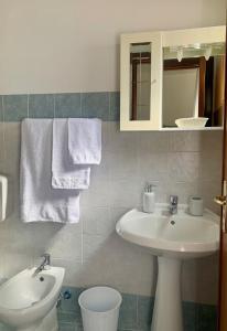 a bathroom with a sink and a toilet and a mirror at Isola delle Femmine Apartment in Capaci in Capaci