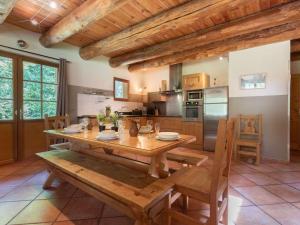 a large kitchen with a wooden table and chairs at Maison Aragnouet, 5 pièces, 10 personnes - FR-1-296-343 in Aragnouet