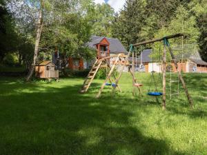 a playground in a yard with a wooden swing at Maison Aragnouet, 5 pièces, 10 personnes - FR-1-296-343 in Aragnouet