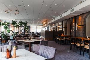 a dining room with tables and chairs and a restaurant at Piteå Stadshotell in Piteå