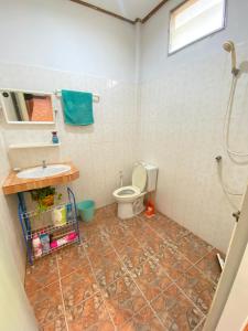 a bathroom with a toilet and a sink at Jungle house in Baan Tai