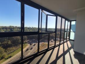 a view from a room with windows at Serene Parkside Retreat 2Brs@ close 2 Olympic park in Sydney