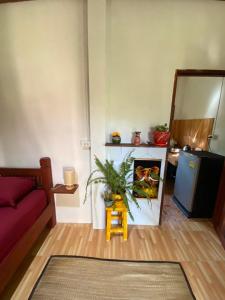 a living room with a couch and a fire place at Jungle house in Baan Tai