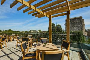 a patio with tables and chairs on a roof at Courtyard by Marriott Oxford City Centre in Oxford