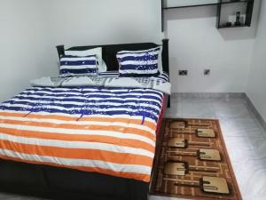 a bedroom with an american flag bed with blue and white pillows at furnished 4 bd hse with pool in Accra