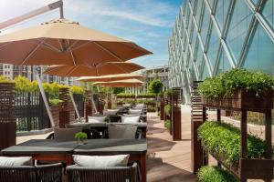 a row of tables with umbrellas outside a building at JW Marriott Hotel Yinchuan in Yinchuan