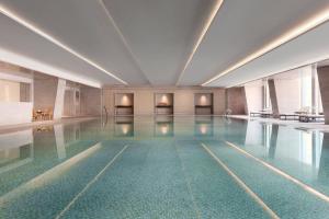 a swimming pool in a building with a pool at JW Marriott Hotel Yinchuan in Yinchuan