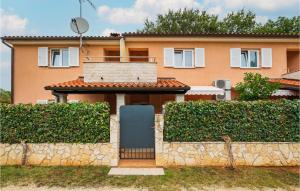 a house with a stone fence and a blue door at Beautiful Apartment In Pula With 1 Bedrooms And Wifi in Pula