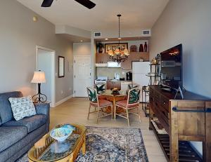a living room with a couch and a table at Lovers Key Resort Penthouse 3 in Fort Myers Beach