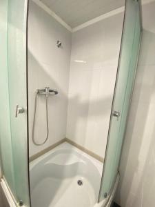 a shower with a glass door in a bathroom at Prykarpatska Villa in Morshin