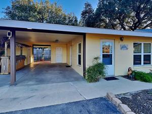 a house with a garage with a driveway at Harbor Lights Cottages 3 in Rockport