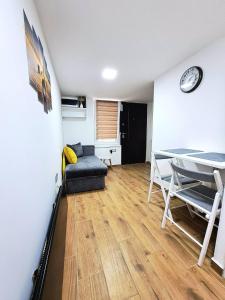 a living room with a couch and a table at Mini duplex apartman in Dušanovac (historical)
