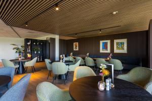a dining room with tables and chairs and tablesktop at Postillion Utrecht Bunnik in Bunnik +33 photos