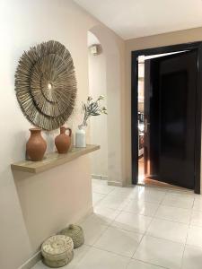 a hallway with a large fan on a wall at Marbella Holiday Homes - Al Nahda 2BHK in Dubai