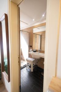 a bathroom with a sink and a toilet and a mirror at Hotel Esperia in Genoa