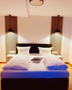 1 dormitorio con 1 cama grande con sábanas y almohadas azules en Ferienwohnung ,,Doina", en Gehlberg