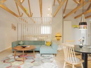 a living room with a blue couch and a table at OSTKÜSTE - Villa Groth Design Apartments in Heringsdorf