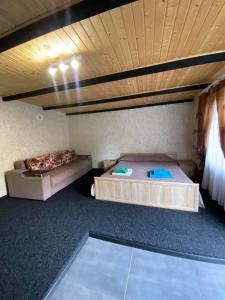 a bedroom with two beds and a wooden ceiling at Prykarpatska Villa in Morshin