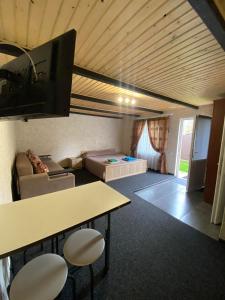 a living room with a couch and a flat screen tv at Prykarpatska Villa in Morshin