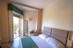 a hotel room with a bed and a balcony at Hotel Esperia in Genoa