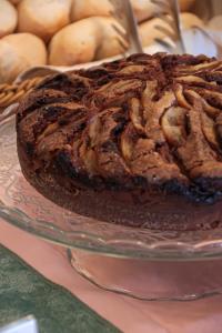 a chocolate cake on a glass plate on a table at Hotel Esperia in Genoa
