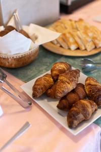 a table with a plate of pastries and bread at Hotel Esperia in Genoa