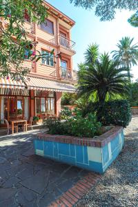 a building with a palm tree in front of it at Hotel Esperia in Genoa