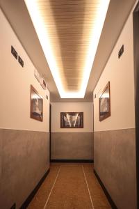 a hallway with a row of halls with a ceiling at Hotel Esperia in Genoa
