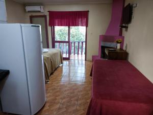 een kamer met een koelkast, een bed en een raam bij Pousada da Chacara in Nova Petrópolis +235 foto's