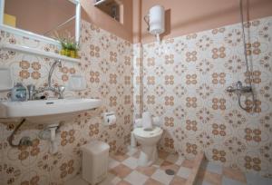 a bathroom with a toilet and a sink at Theodora Studios Best Location In Laganas Next To The Party Area in Laganas