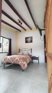 a bedroom with a bed and a tv in it at Sama Jauka in Guano