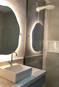 a bathroom with a sink and a mirror at Flats Baia dos Porcos in Fernando de Noronha