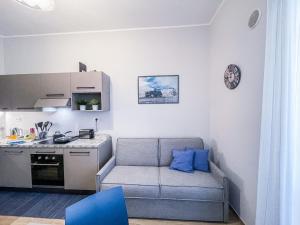 a living room with a couch and a kitchen at MYHOUSE INN 500 - Affitti Brevi Italia in Turin