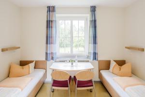 a room with a table and two chairs and a window at Schacht III/ABZ in Gelsenkirchen