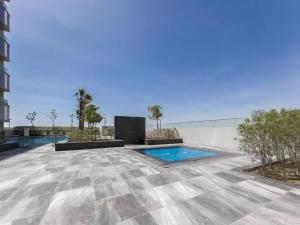 a swimming pool on a roof of a building at StoneTree - Spacious 3 BR in The Pulse C2 in Dubai