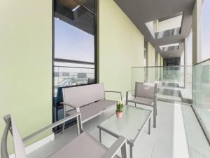 a balcony with two benches and a table in a building at StoneTree - Spacious 3 BR in The Pulse C2 in Dubai