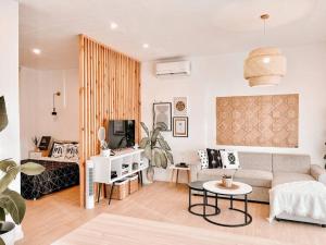 a living room with a couch and a tv at Thalassa Villa Sulangan Beachfront and Sunset in Sarog