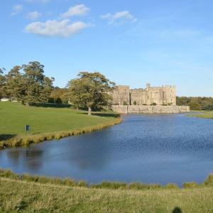 a castle with a lake in front of it at Paradise House Darlington in Darlington