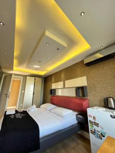 a bedroom with a large bed and a yellow ceiling at The Sisli Luxury Corner Suit in Istanbul