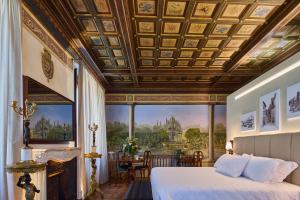 a bedroom with a bed and a large window at Duomo Luxury Florence in Florence