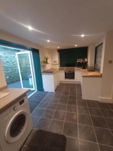 a kitchen with a washer and dryer in a room at Folkestone harbour view in Folkestone