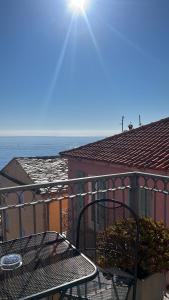 a balcony with a table and a view of the ocean at Hôtel Des Gouverneurs in Bastia
