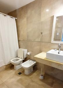 a bathroom with a toilet and a sink at Buena vista PB - Bon Repos in Yerba Buena