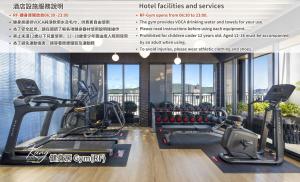 a gym with two treadmills and exercise bikes at JÒHŌ HOTEL Kaohsiung in Kaohsiung